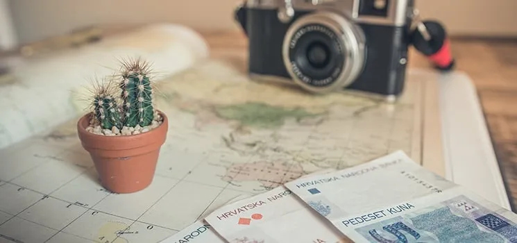 Travel planning notes and a pen
